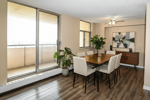 A dining room with a table and chairs.