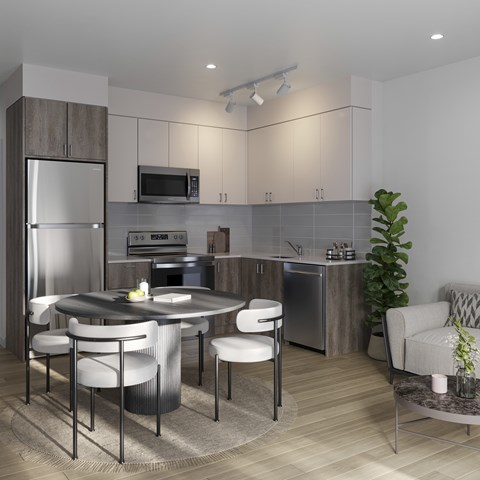 A modern kitchen with a round table and chairs.