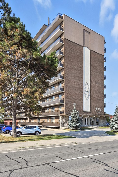 A large building with a tree in front of it.