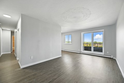 A spacious room with a view of the sky through the windows.
