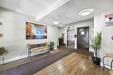 A room with a wooden floor and a bench.