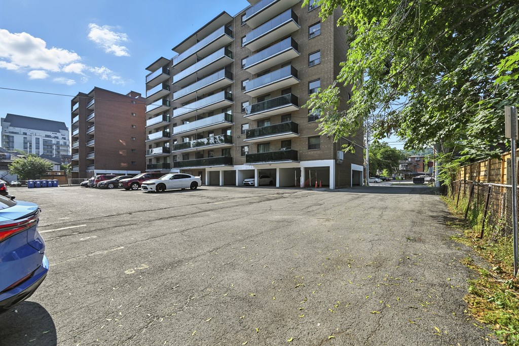 A parking lot with a large building in the background.