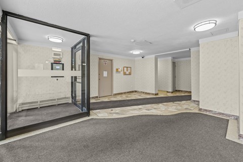 A room with a mirrored door and a carpeted floor.