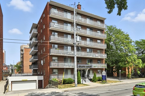 A multi-story apartment building with a balcony on each floor.