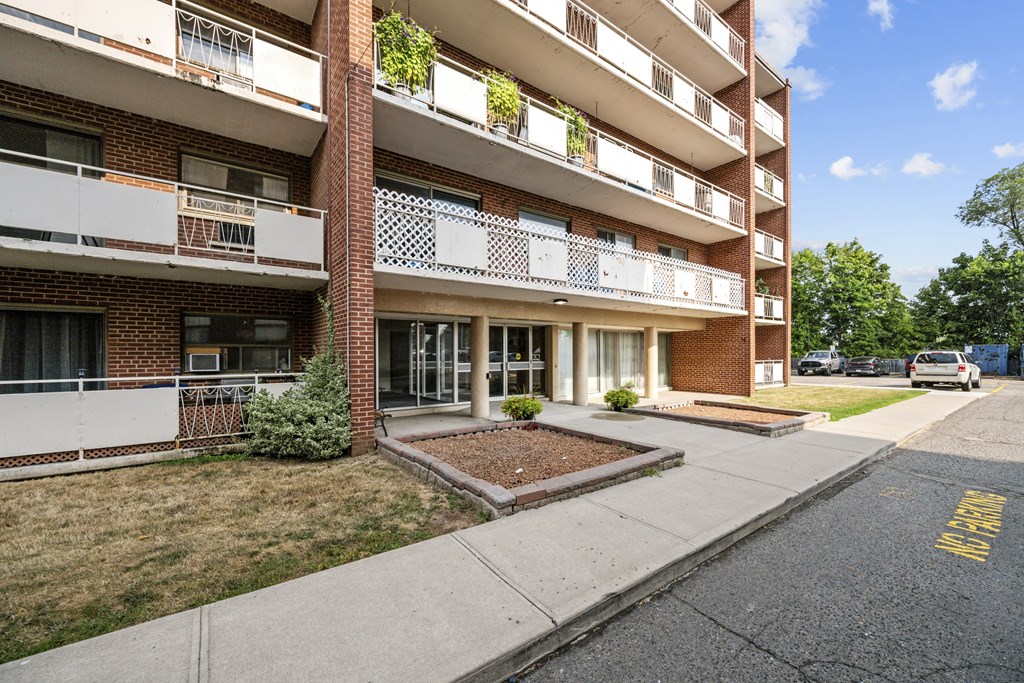 Apartment building with a small garden in front.