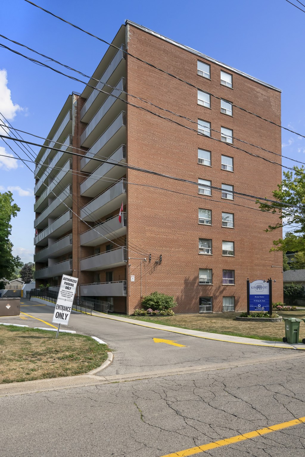 A tall brick building with a sign that says "ONLY" in front of it.