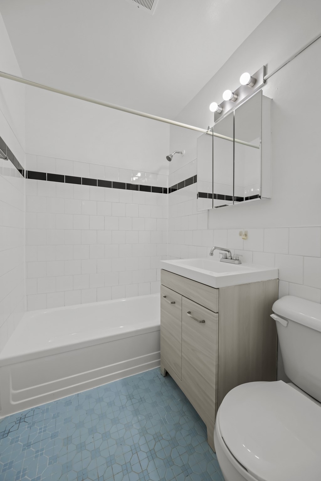 A white toilet sits next to a bathtub in a bathroom.