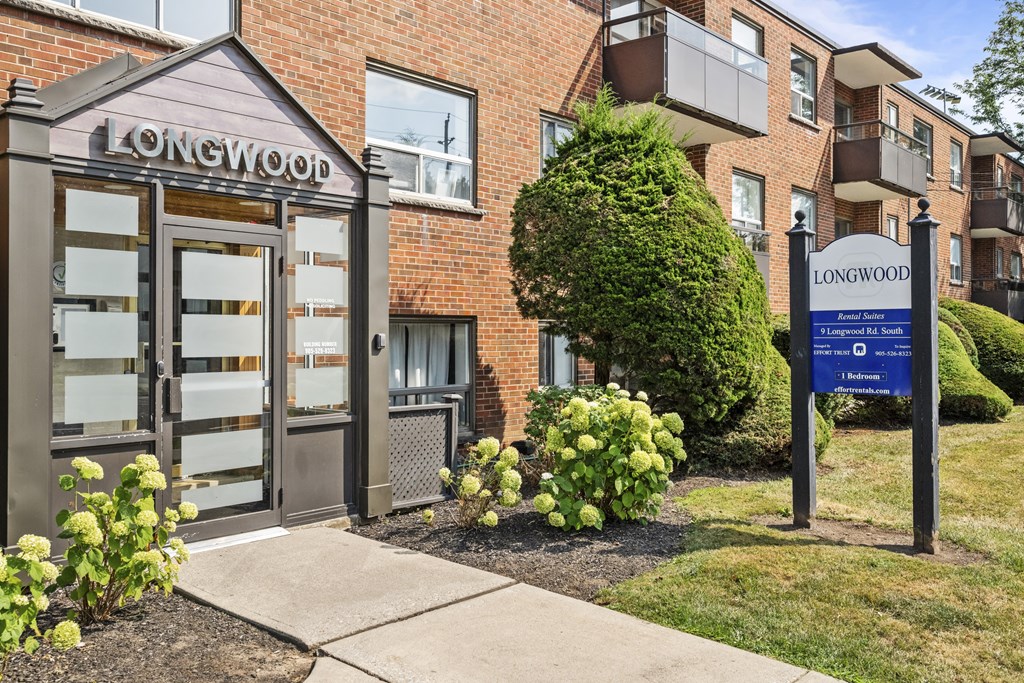 The front of a brick building with a sign that says Longwood.