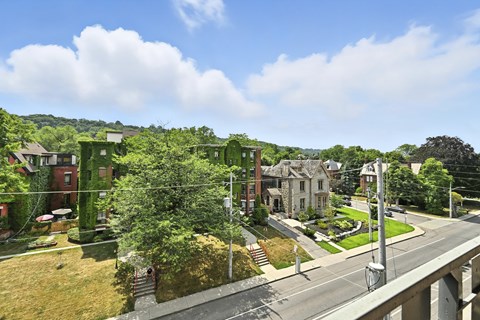A street view of a residential area with houses on both sides.