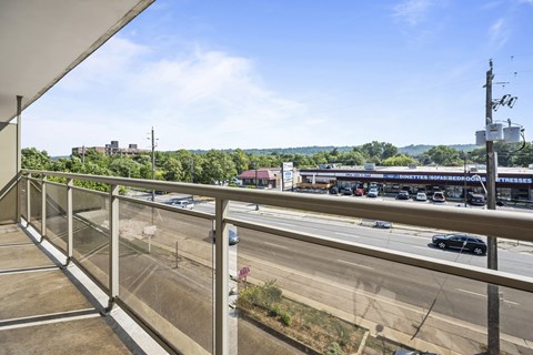 A view from a balcony overlooking a busy highway.
