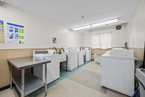 A laundry room with washers and dryers.