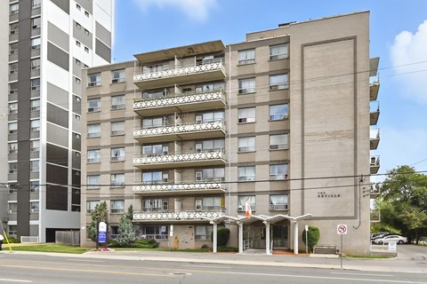 A large apartment building with a balcony on the second floor.