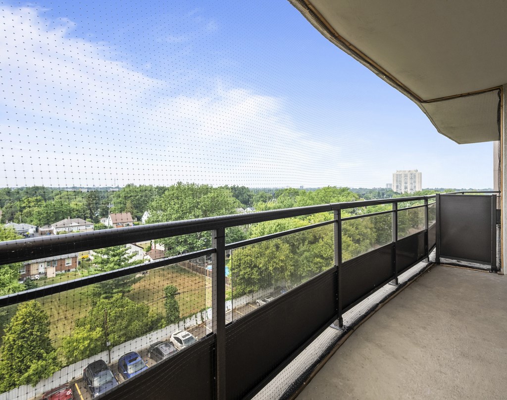 A balcony with a view of a residential area.