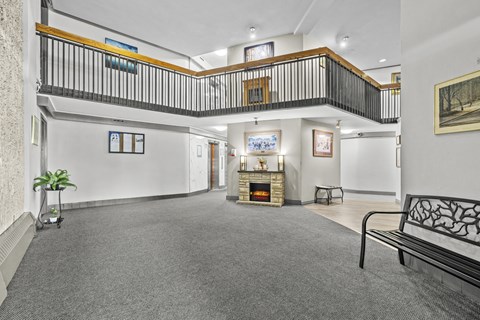 A living room with a fireplace and a balcony.