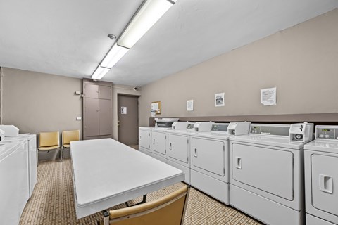 A laundry room with washers and dryers.