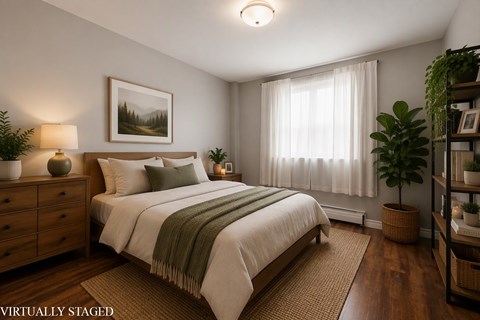 A bedroom with a bed, nightstand, and a painting on the wall.