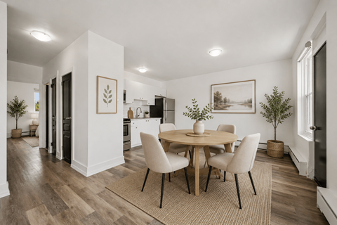 A dining room with a table set for four.