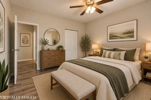 A bedroom with a bed, dresser, and mirror.