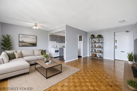 A living room with a couch, coffee table, and a painting on the wall.