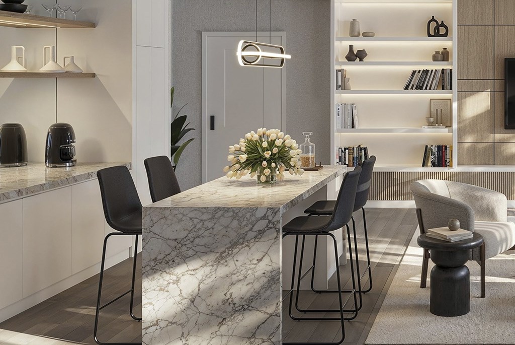 A modern dining room with a marble table and black chairs. A modern dining room with a marble table and black chairs at Roxy Apartments, Ontario