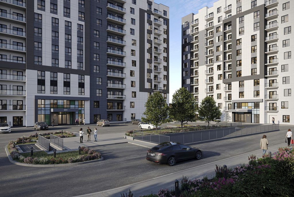 A car is driving down a street lined with modern apartment buildings. A car is driving down a street lined with modern apartment buildings at Roxy Apartments, Hamilton, ON, L8H 0B7