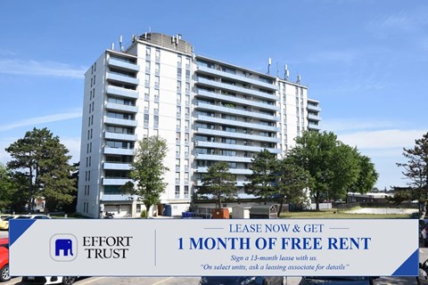 A large white building with a sign in front that says "Effort Trust 1 Month of Free Rent".