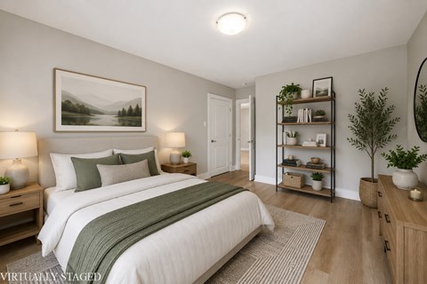 A bedroom with a large bed and a painting on the wall.