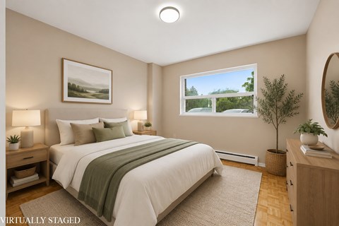 A bedroom with a large bed and a painting on the wall.
