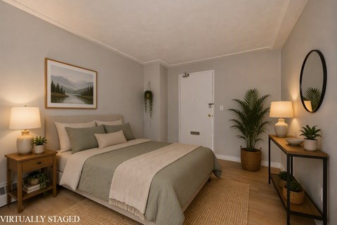 A bedroom with a bed, nightstands, and a painting on the wall.