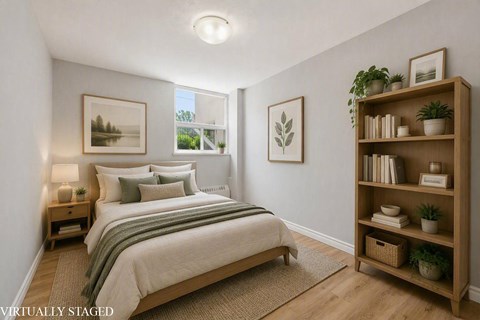A bedroom with a bed, nightstand, and a bookshelf.