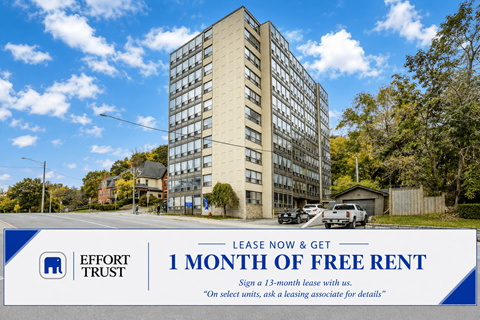 A tall building with a sign offering 1 month of free rent.