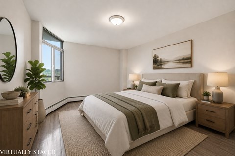 A bedroom with a large bed, a mirror, and a painting on the wall.