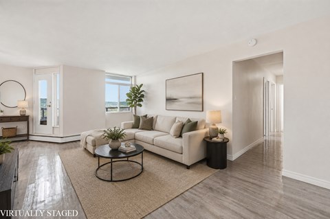 A living room with a white couch and a coffee table.