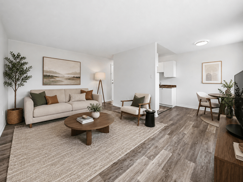 A living room with a couch, chairs, and a coffee table.