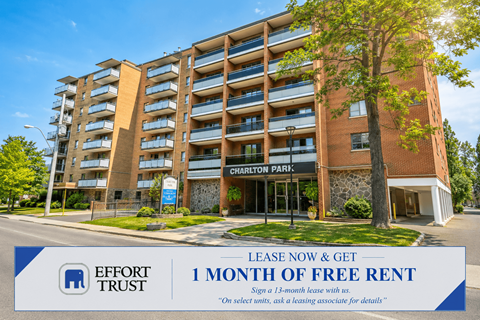 A tall apartment building with a sign offering 1 month free rent.