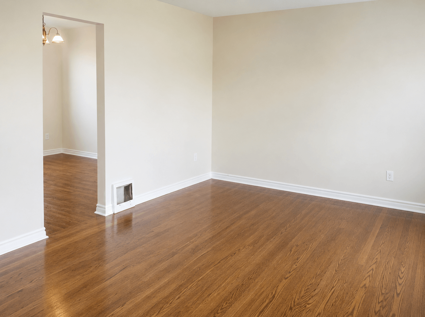A room with wooden floors and a white door.