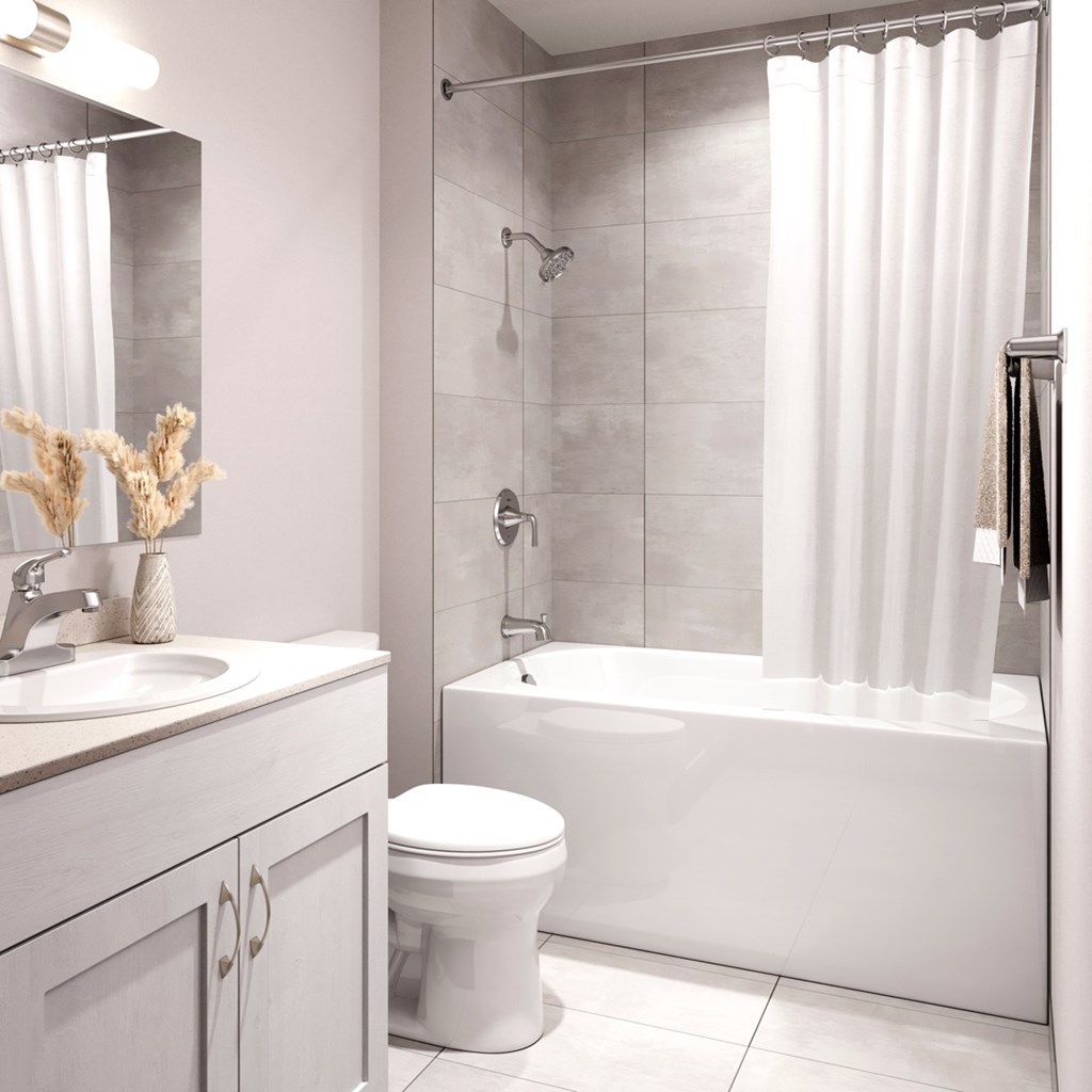 A white bathroom with a toilet, sink, and bathtub.at The Maverick, Kitchener, N2H 0E3