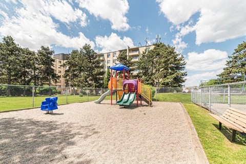 A playground with a slide, swings, and a sandbox.