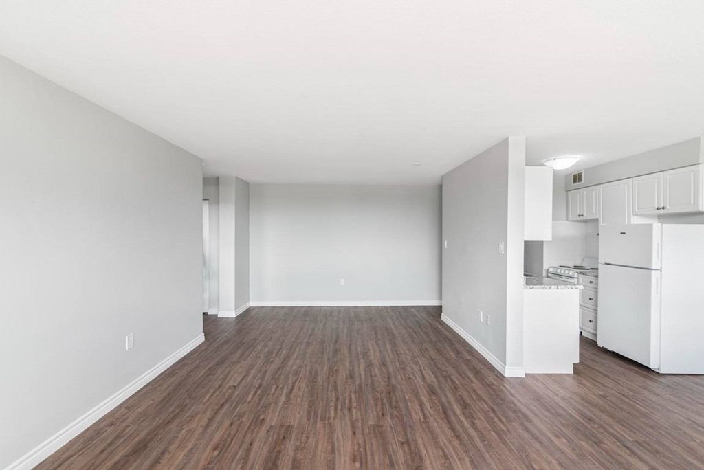 A room with wooden floors and white walls.