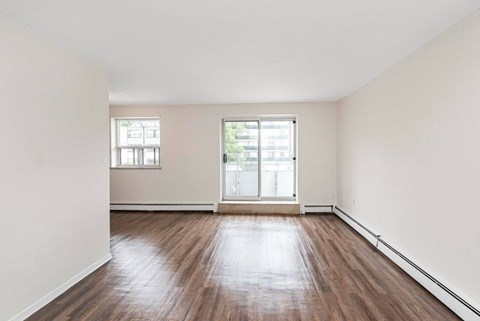 A room with wooden floors and a window.