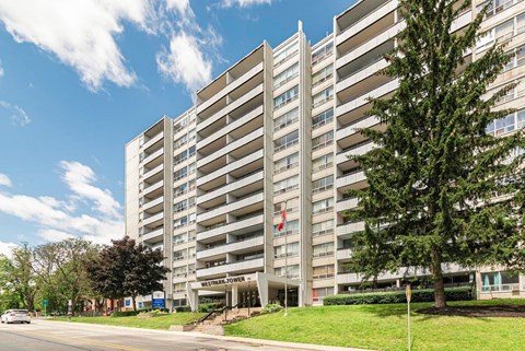A tall building with the words "Westhills Towers" on the front.