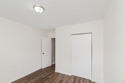 A room with a white door and a white wall.