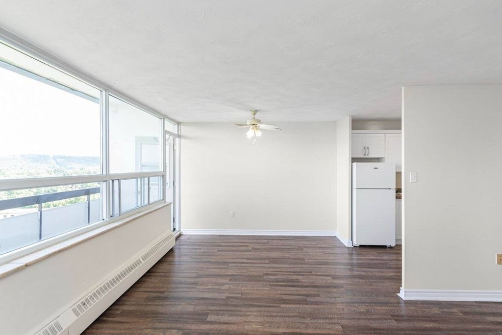 A room with a white ceiling and a white refrigerator.