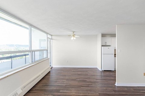 A room with a white ceiling and a white refrigerator.