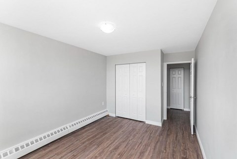 A room with a white wall and a white door.