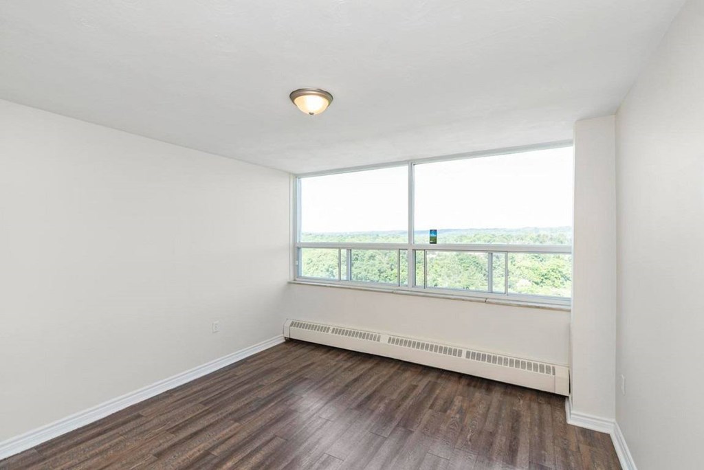 A room with a window and a view of the outdoors.