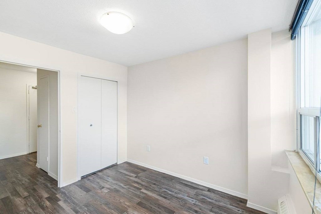 A room with a white door and a window.