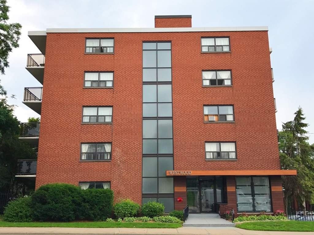 A red brick building with a glass entrance and a sign that says Westward.