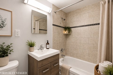 A bathroom with a white sink and a white bathtub.