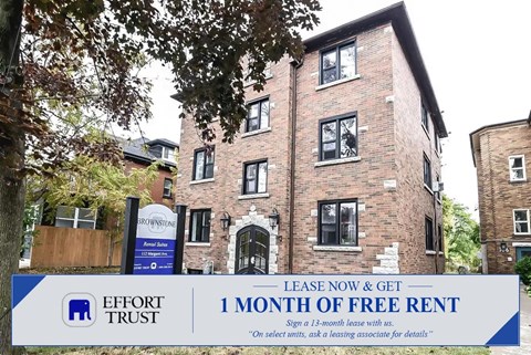 A large brick building with a sign offering free rent for the first month.